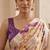 Cream women cream coloured purple floral printed pre draped saree