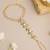 Gold plated kundan white and green haathphool