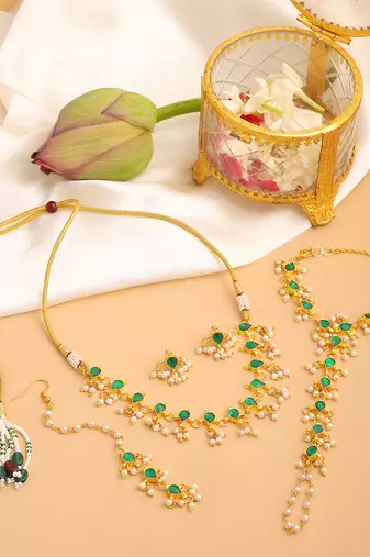 Gold plated kundan green stone necklace set with maang tikka and haathphool