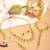 Gold plated kundan green stone necklace set with maang tikka and haathphool