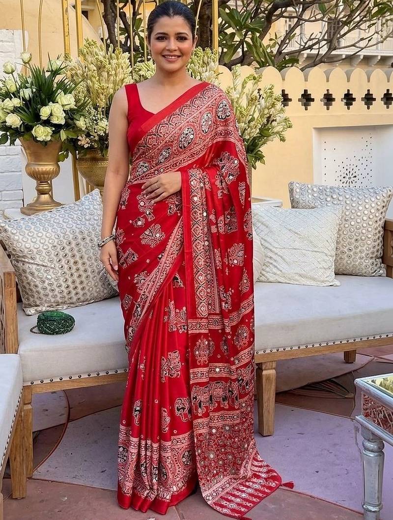 Red women embellished mirror work saree