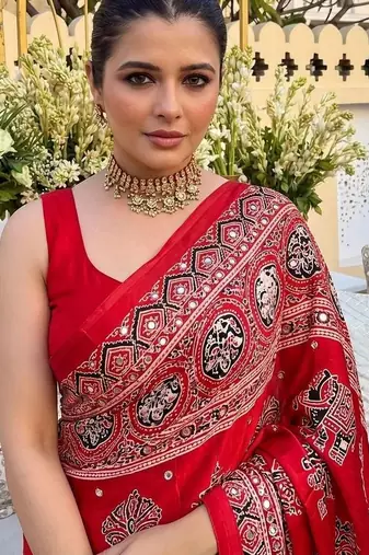 Red women embellished mirror work saree