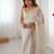 Off white sequinned  georgette embellished party wear saree with matching blouse