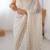 Off white sequinned  georgette embellished party wear saree with matching blouse