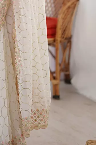 Off white sequinned  georgette embellished party wear saree with matching blouse