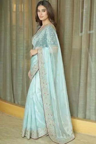 Turquoise embellished embroidered tissue saree