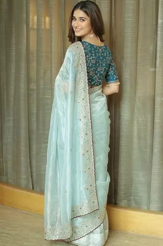 Turquoise embellished embroidered tissue saree