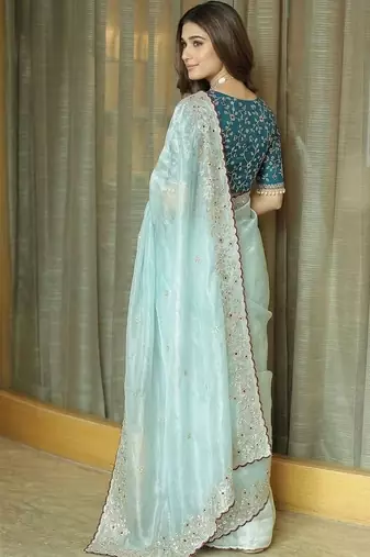 Turquoise embellished embroidered tissue saree