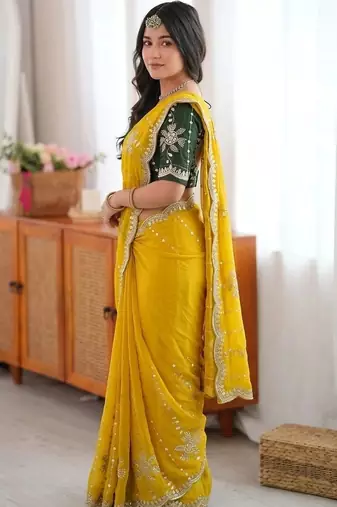 Yellow ethnic motifs sequinned  georgette saree
