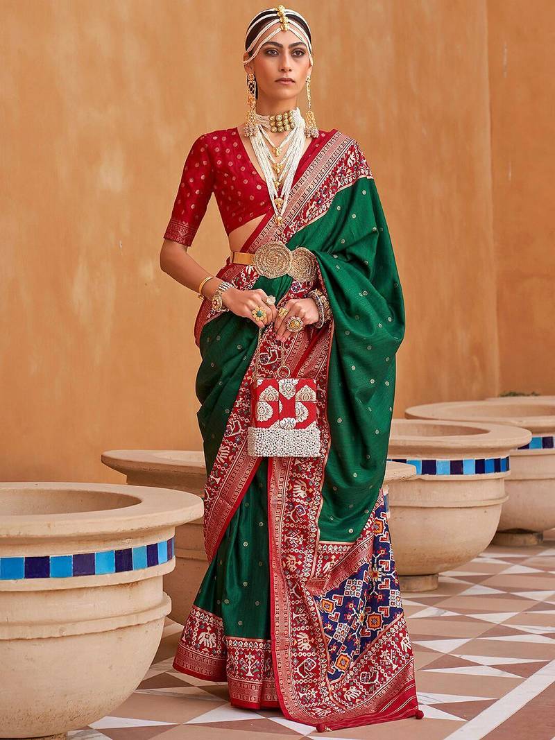 Green ethnic motifs woven design patola saree