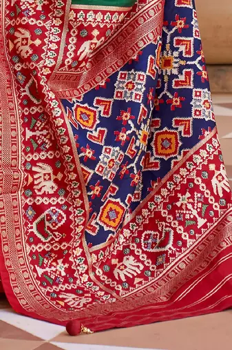 Green ethnic motifs woven design patola saree
