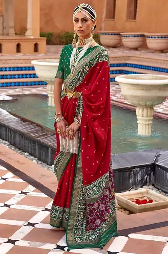 Red ethnic motifs woven design zari patola saree
