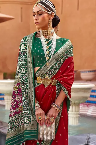 Red ethnic motifs woven design zari patola saree