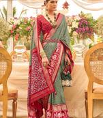 Green ethnic motifs woven design zari patola saree