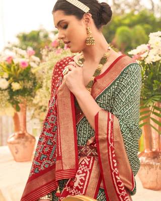 Green ethnic motifs woven design zari patola saree 3