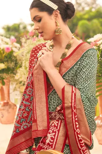Green ethnic motifs woven design zari patola saree