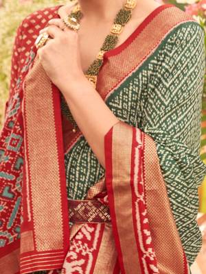 Green ethnic motifs woven design zari patola saree 4