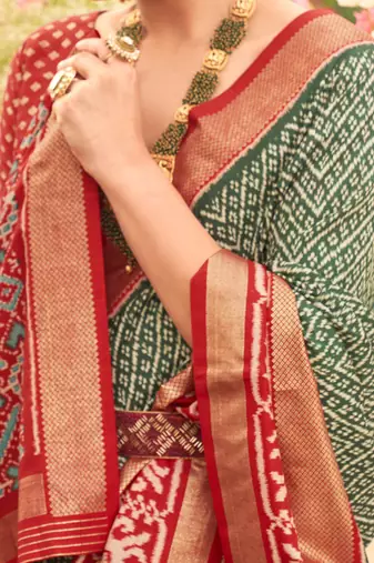 Green ethnic motifs woven design zari patola saree
