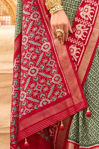 Green ethnic motifs woven design zari patola saree
