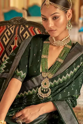 Green ethnic motif printed zari ikat saree