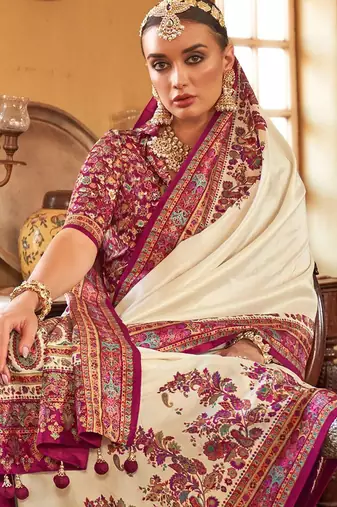 Cream ethnic motifs printed saree