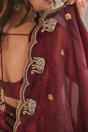 maroon ethnic motifs beads and stones satin heavy work saree