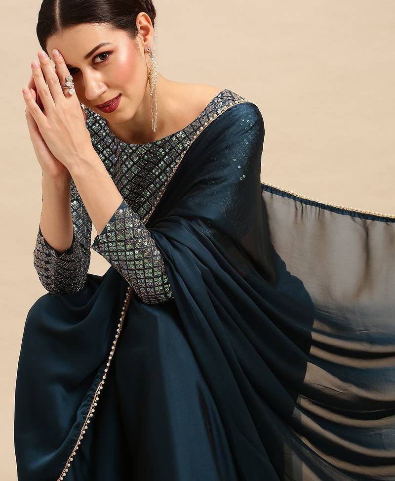 Teal sequinned  georgette saree
