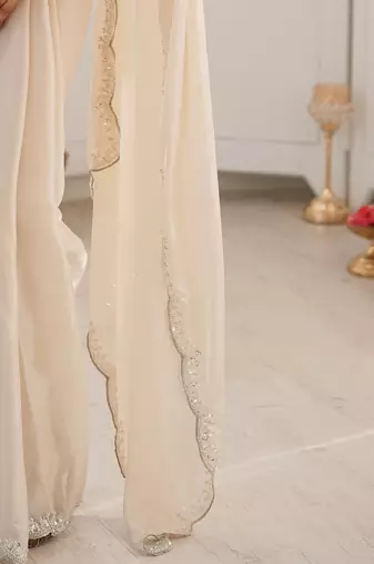 Off white embellished sequinned satin heavy work saree