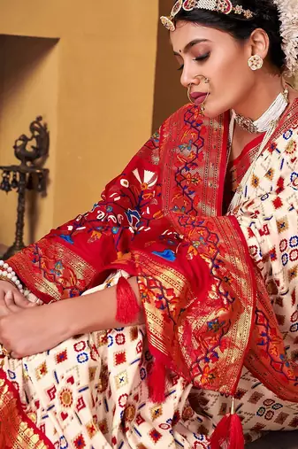Off white ethnic motifs woven design zari patola saree
