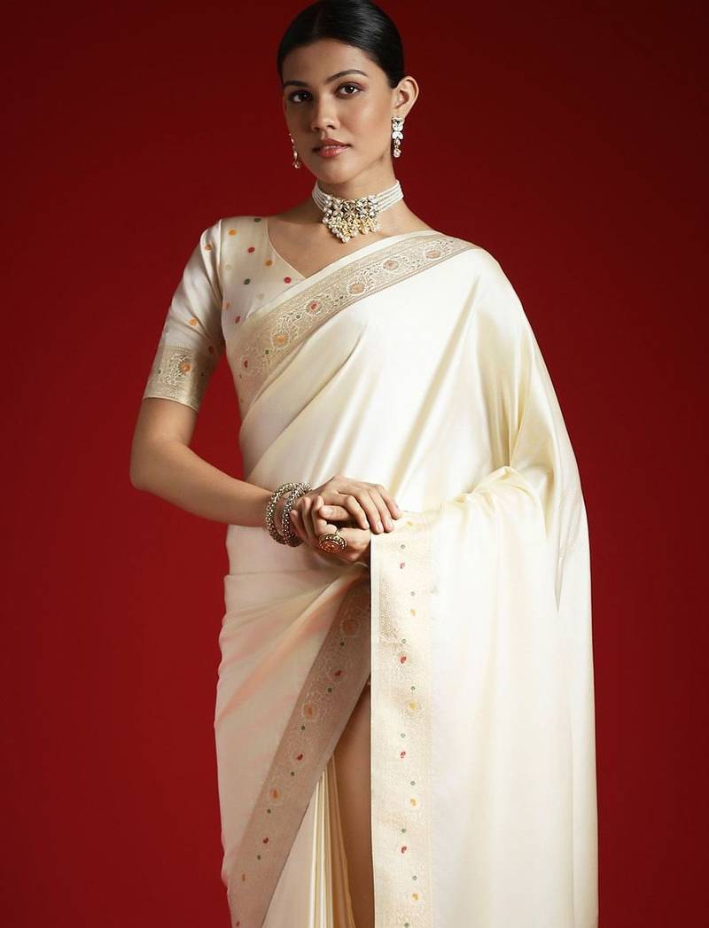 Cream cream solid zari woven design satin banarasi saree with matching blouse