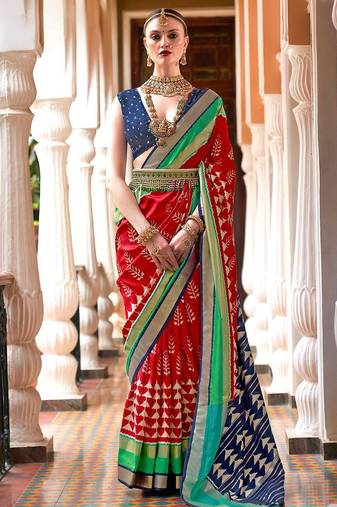 Red ethnic motifs woven design zari ikat saree