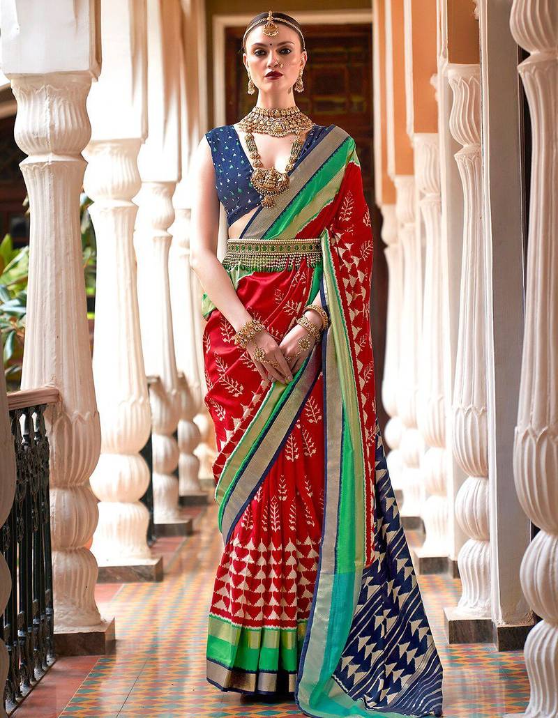 Red ethnic motifs woven design zari ikat saree