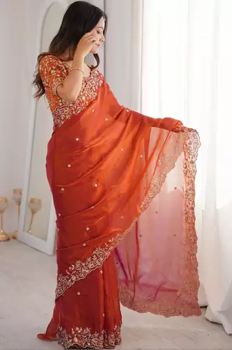 Rust ethnic motifs embroidered satin heavy work saree