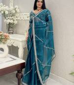 Teal ethnic motifs embroidered organza saree