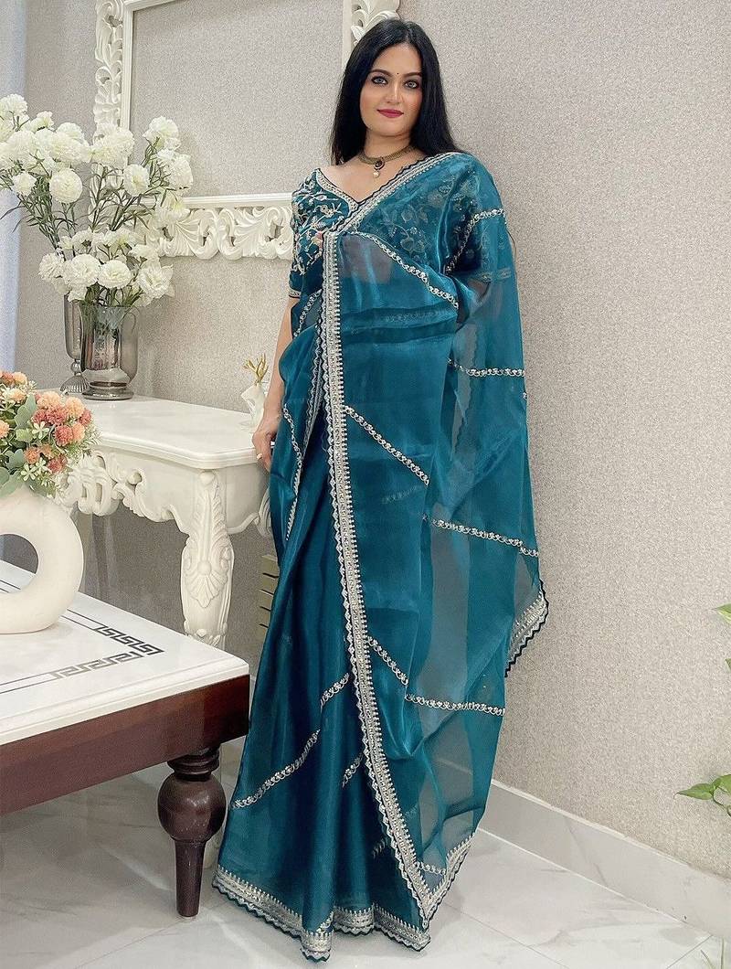 Teal ethnic motifs embroidered organza saree