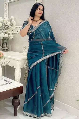 Teal ethnic motifs embroidered organza saree