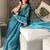 Teal ethnic motifs embroidered organza saree