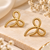Gold bow stud earrings, twisted rope design, anti-tarnish