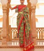 Green ethnic motifs printed zari ikat saree