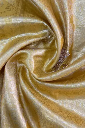 Yellow woven design beads and stones silk blend banarasi saree