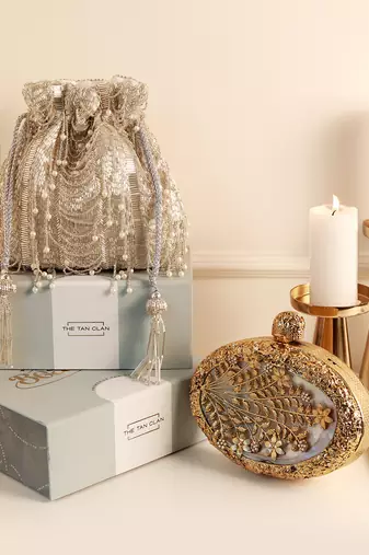 Gold mother of pearl clutch and silver potli bag combo