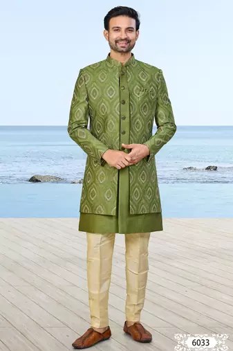 Olive green sherwani with gold detailing and cream trousers—ideal for celebrations.