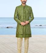 Olive green sherwani with gold detailing and cream trousers—ideal for celebrations.