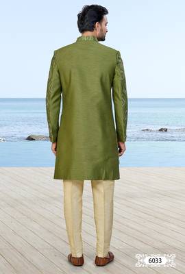 Olive green sherwani with gold detailing and cream trousers—ideal for celebrations. 4