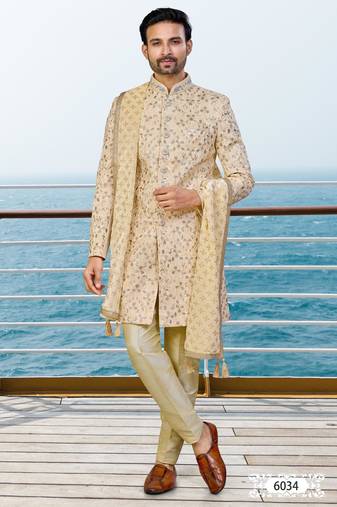 Fown colour sherwani with gold embroidery and matching trousers—perfect for weddings.