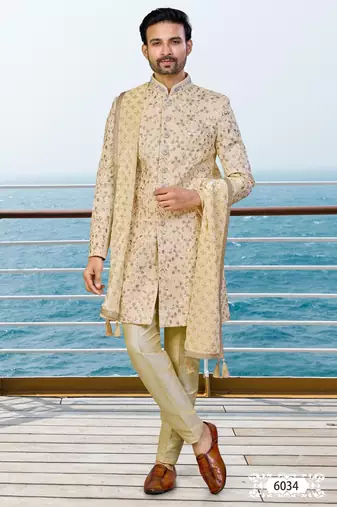 Fown colour sherwani with gold embroidery and matching trousers—perfect for weddings.