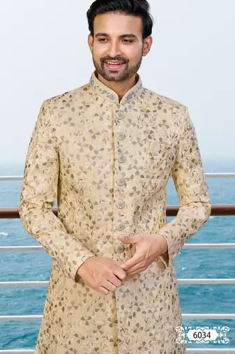 Fown colour sherwani with gold embroidery and matching trousers—perfect for weddings.