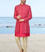 Red sherwani with gold detailing and cream trousers—perfect for weddings and celebrations.