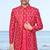 Red sherwani with gold detailing and cream trousers—perfect for weddings and celebrations.