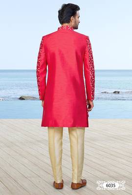 Red sherwani with gold detailing and cream trousers—perfect for weddings and celebrations. 4